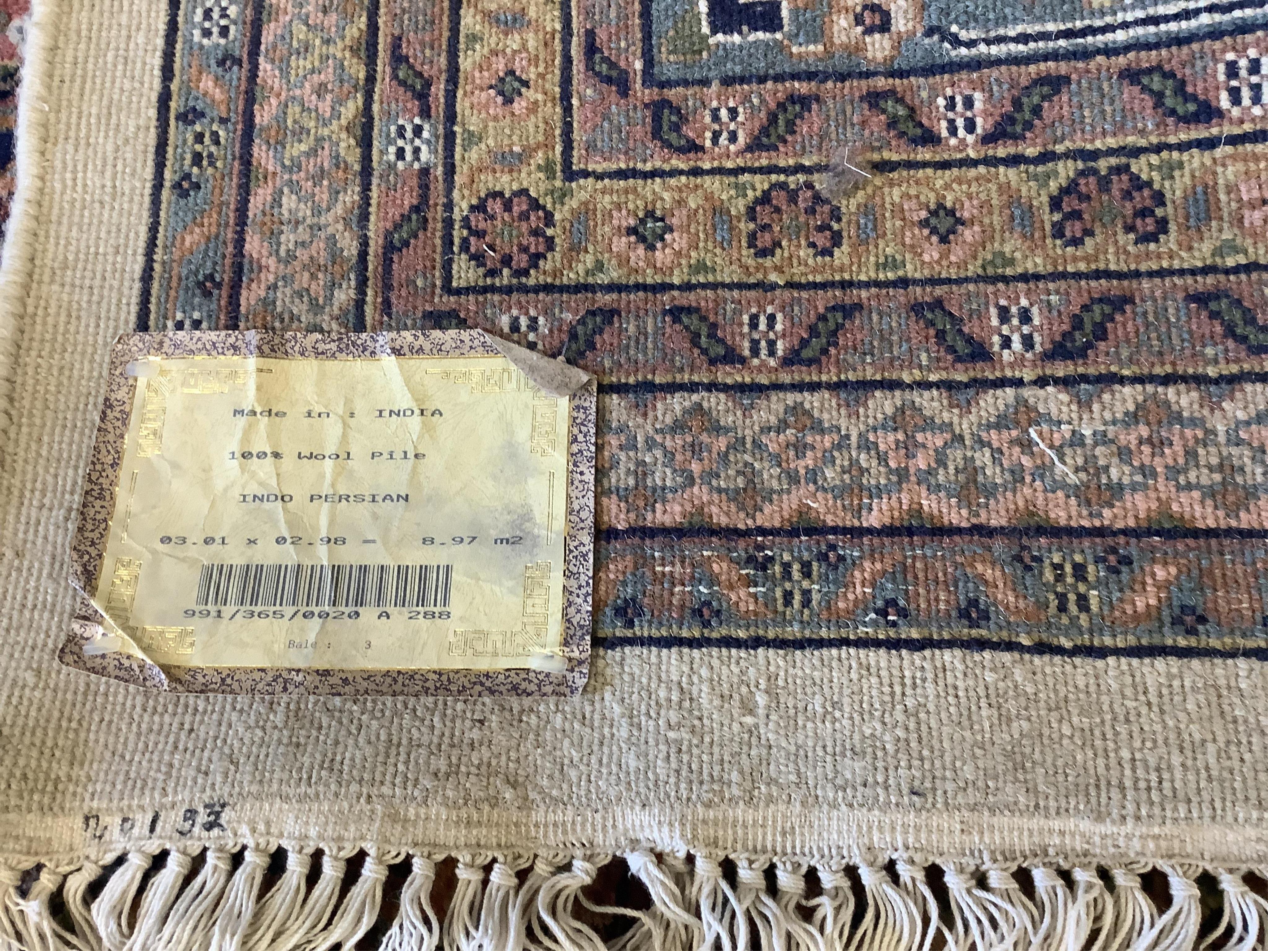 A pair of North West Persian ivory ground carpets, each 294 x 299cm. Condition - fair